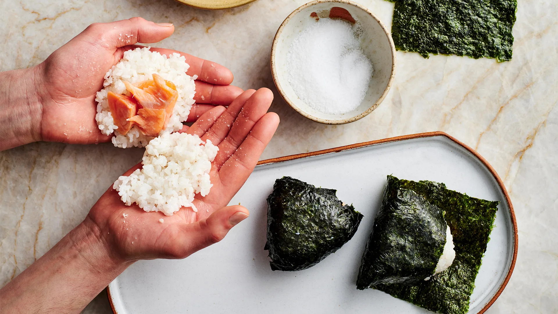 Wrapping the salmon and rice in nori.