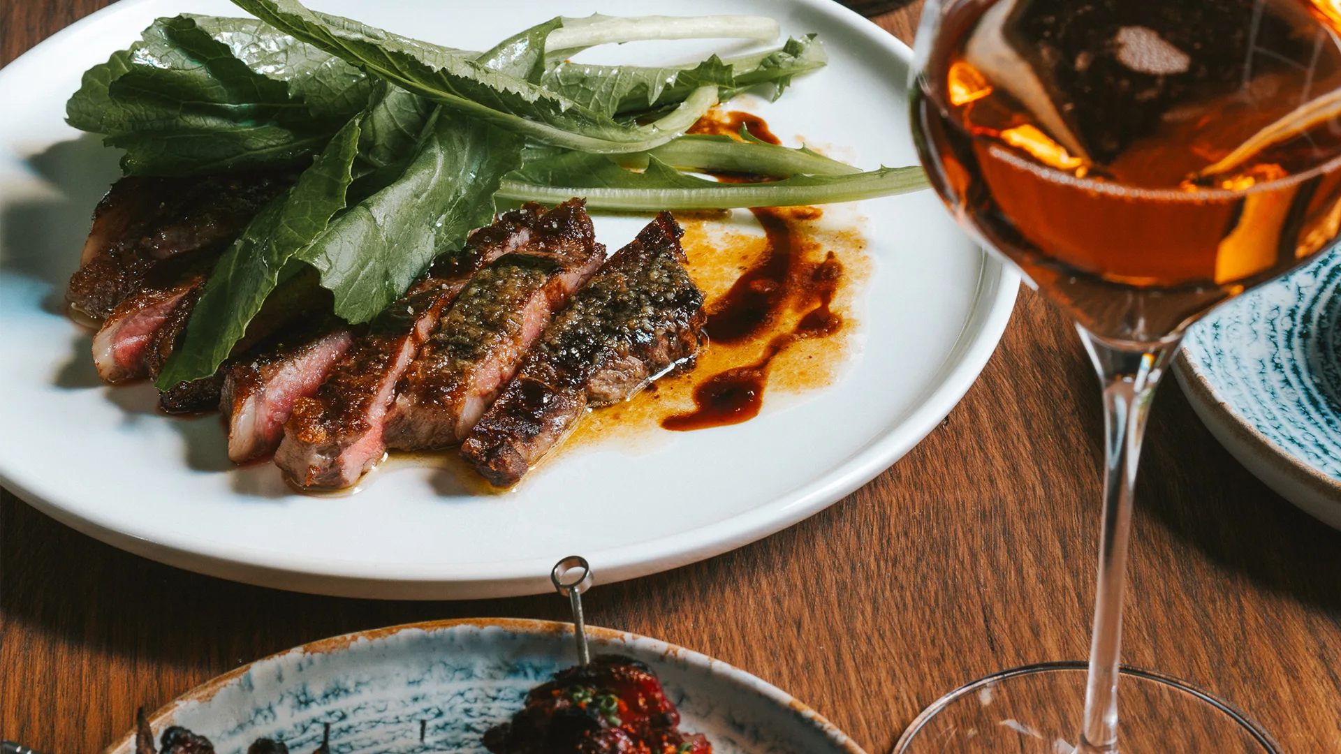 Reed House's Porterhouse steak, anchovy butter and mustard greens.