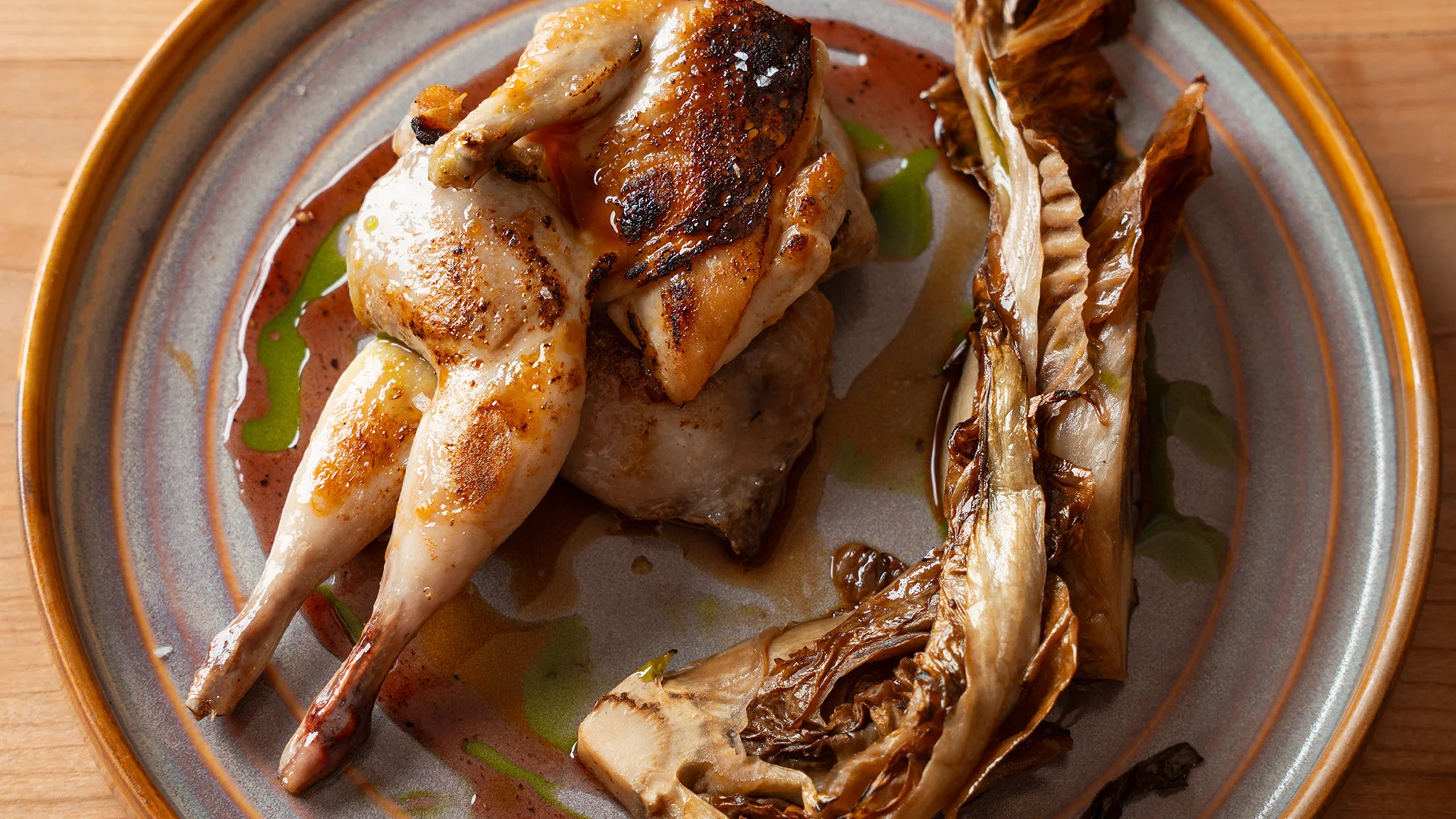 Quail. mulberry and black pepper molasses glaze with charred radicchio.