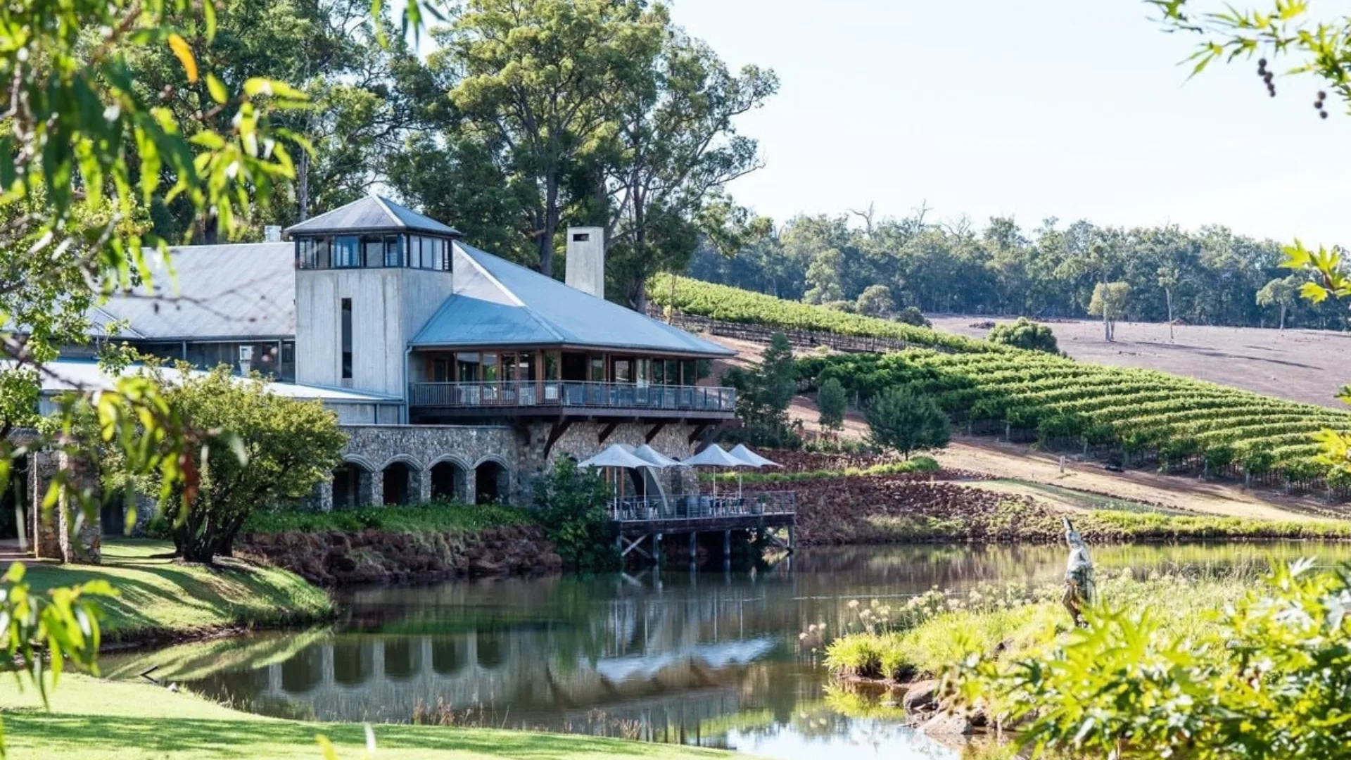 The facade of Millbrook Winery restaurant, set against an expansive lake.