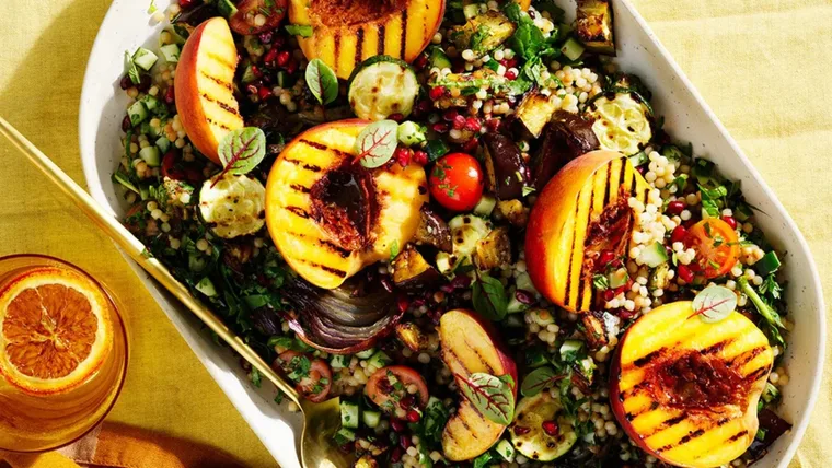 Photo of a bright platter of tabbouleh with eggplant and grilled peaches.