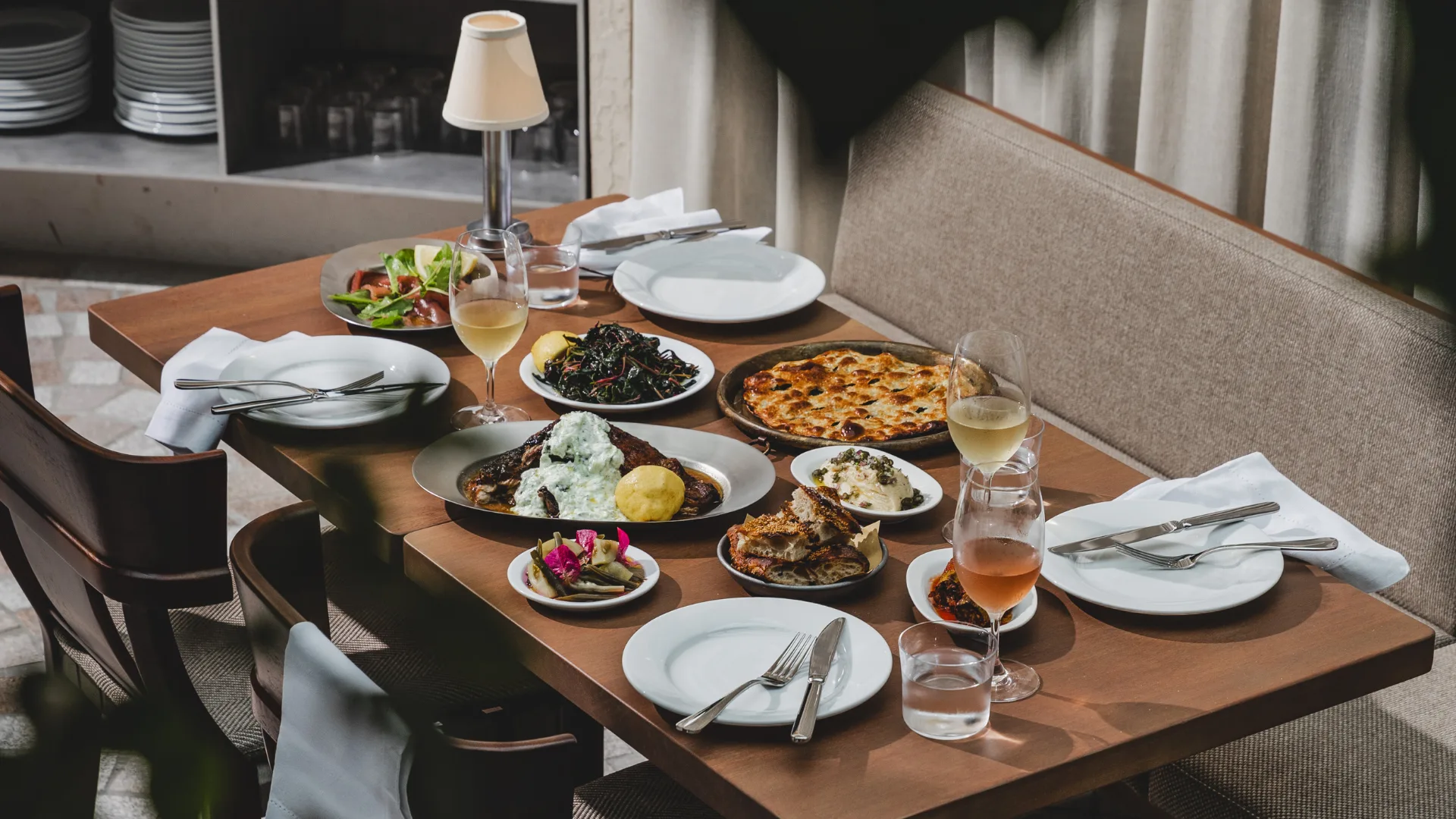 A table with food and wine at Olympus dining on Wunderlich Lane