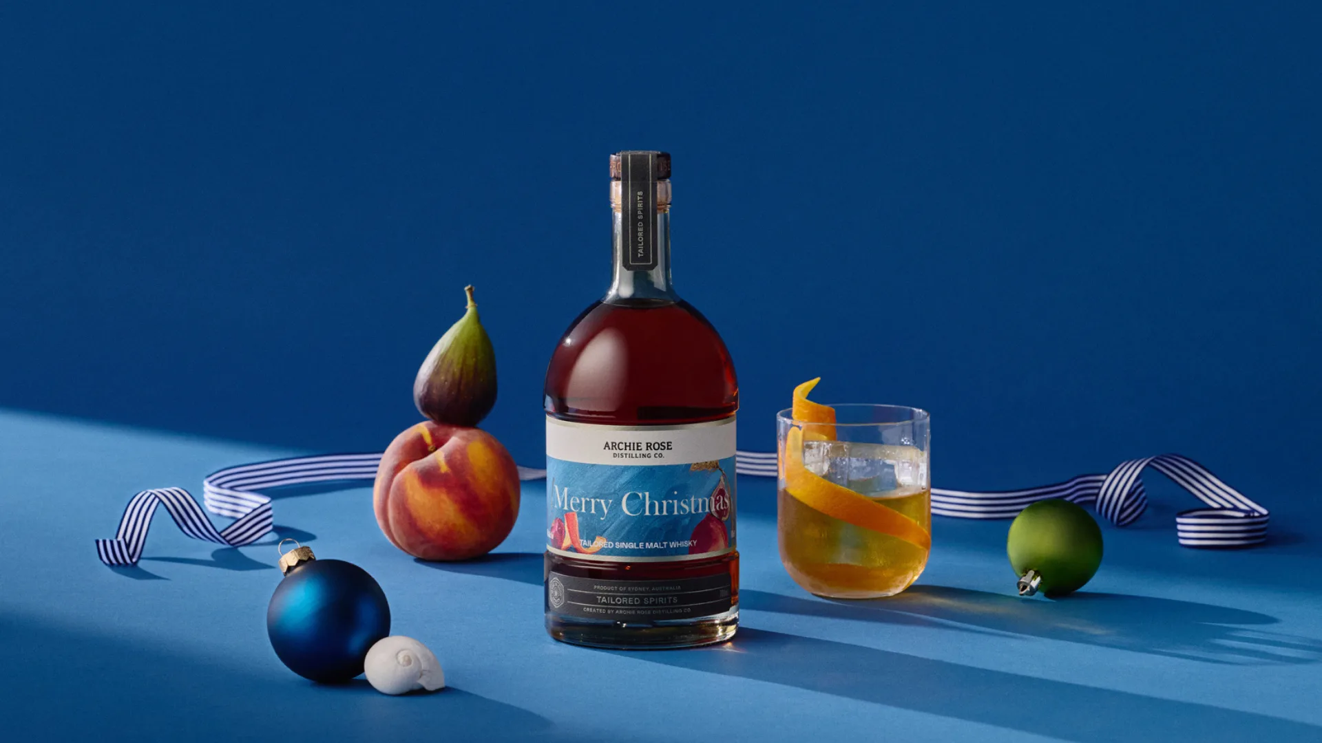 Archie Rose tailored whisky bottle with a cocktail and Christmas baubles