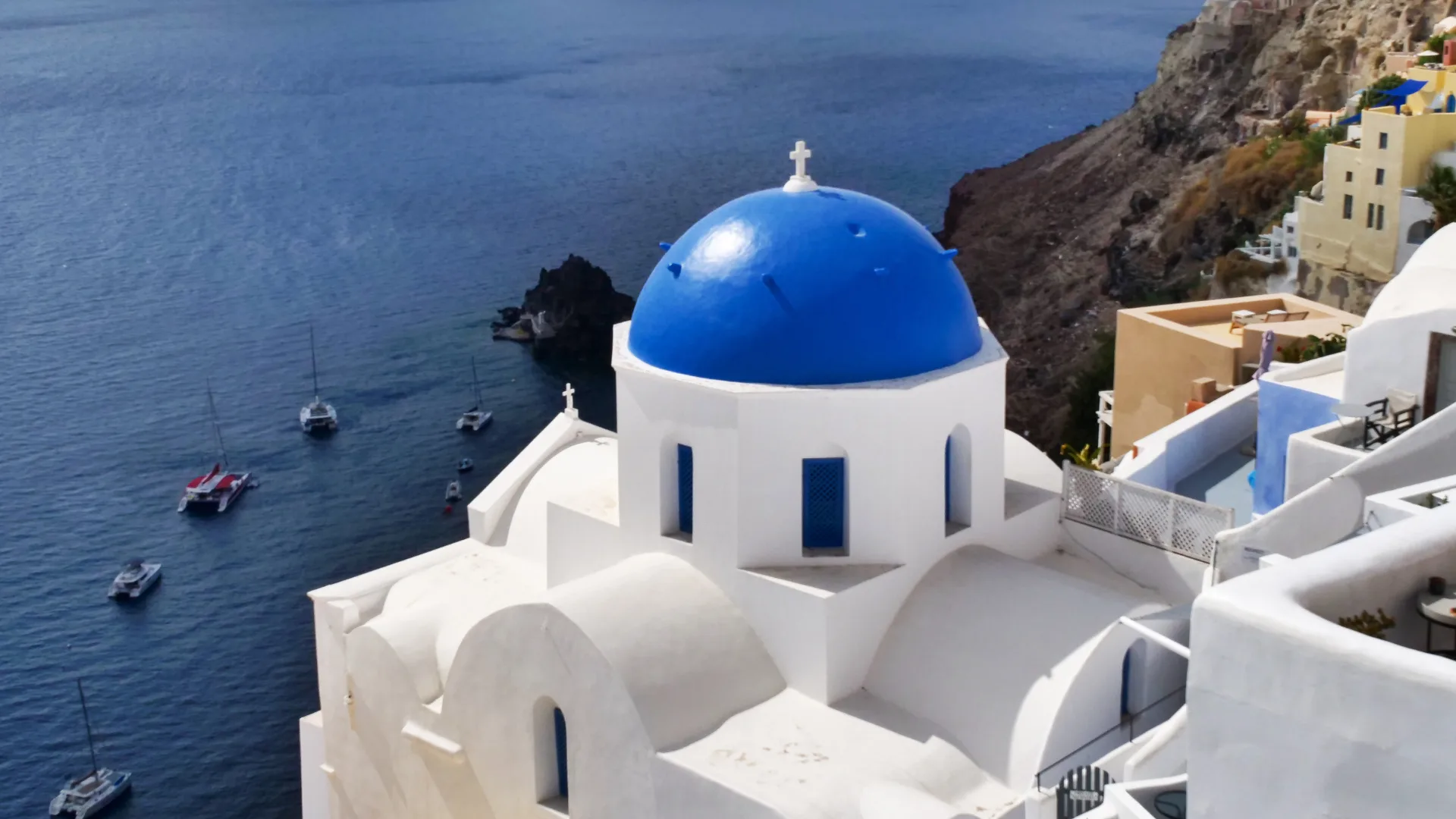 A blue-domed church in Santorini, a day destination on board the Silver Ray