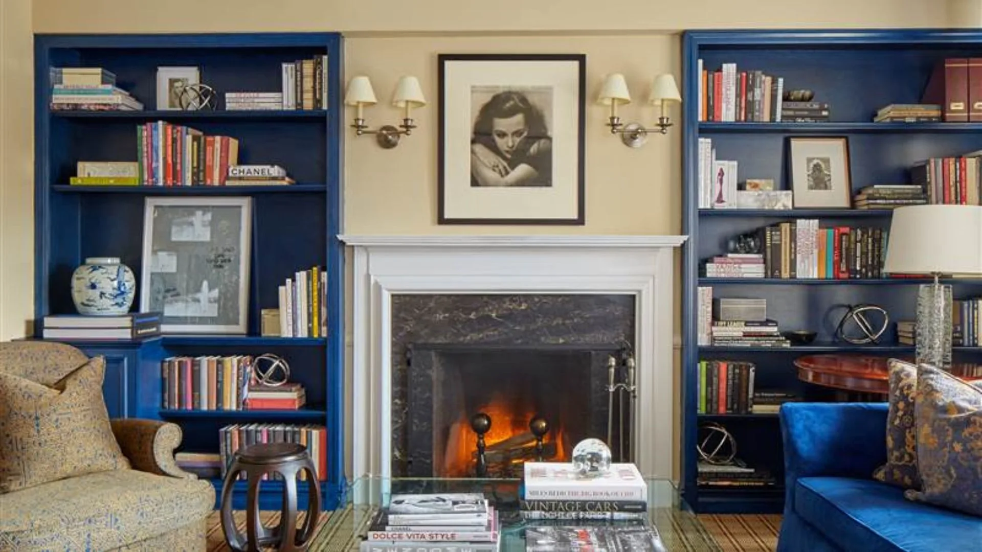 A wood-burning fireplace and blue bookshelves are standout features in The Lowell's Hollywood Suite