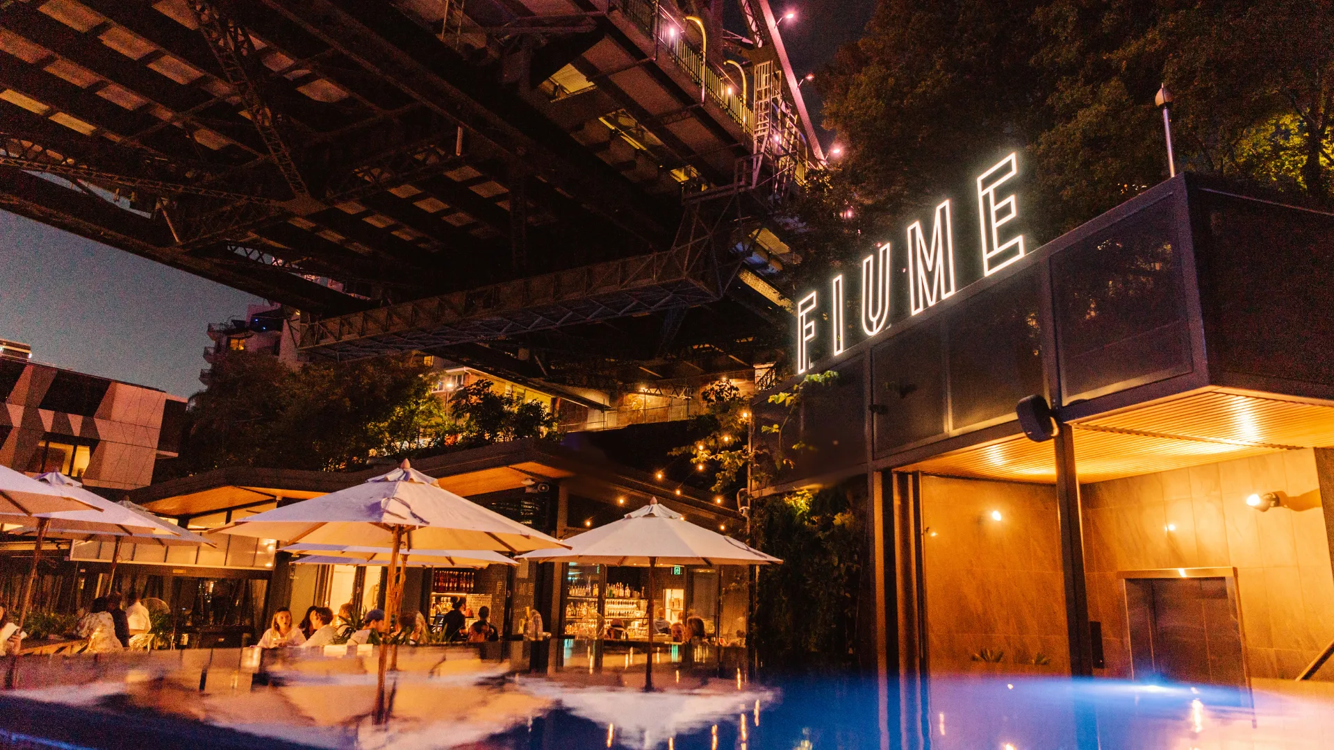 Fiume Rooftop Bar at the Crystalbrook Vincent lit up for nighttime revelry