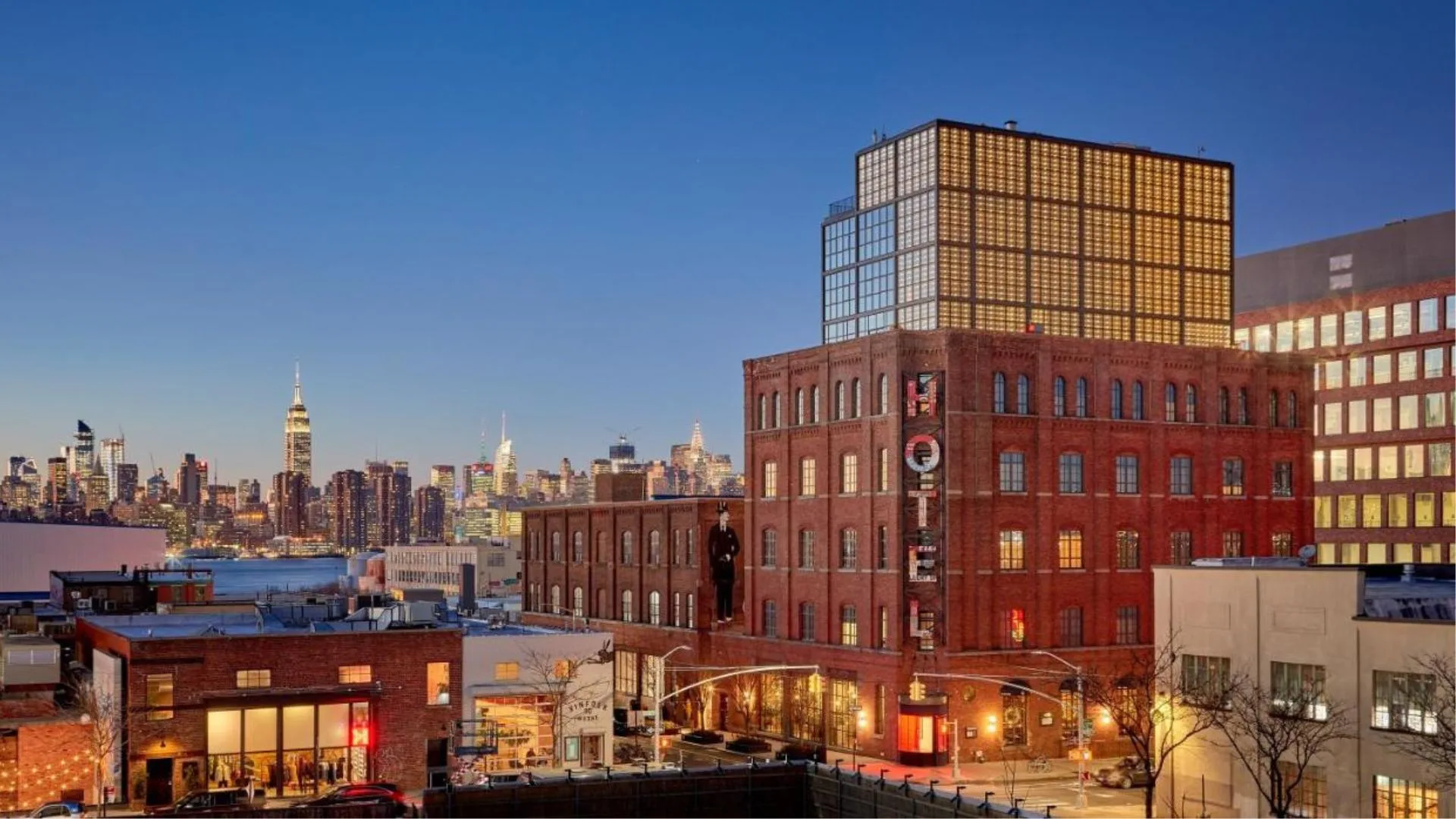Exterior of Wythe Hotel in Brooklyn with Manhattan skyline in background