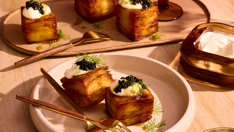 Photo of 15-hour salt and vinegar potato bites topped with cr&egrave;me fra&icirc;che and caviar