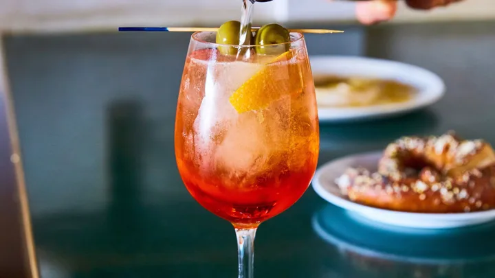 Aperol spritz being poured as a Christmas cocktail recipe