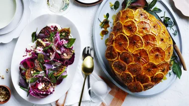 christmas recipes of a ham covered in oranges and a purple and green leaf salad side dish