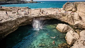people jumping into puglia ocean and swimming
