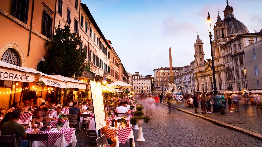 A busy restaurant lined street in Rome.