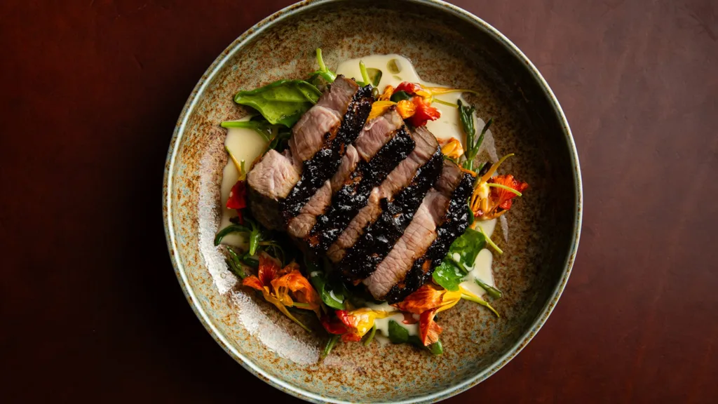 Pork neck at Kiln, which is slow cooked in seaweed and grilled over the fire, then served with a kelp, mussel & karkalla sauce