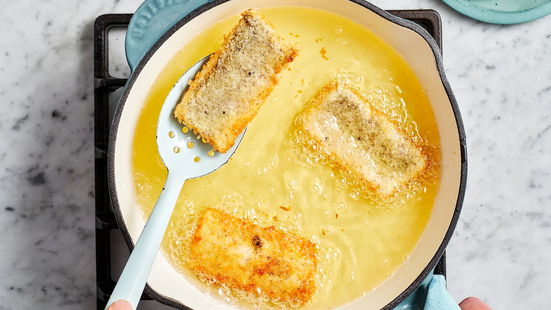 Shallow-frying the sand whiting for the fourth step in our fish sandwich recipe