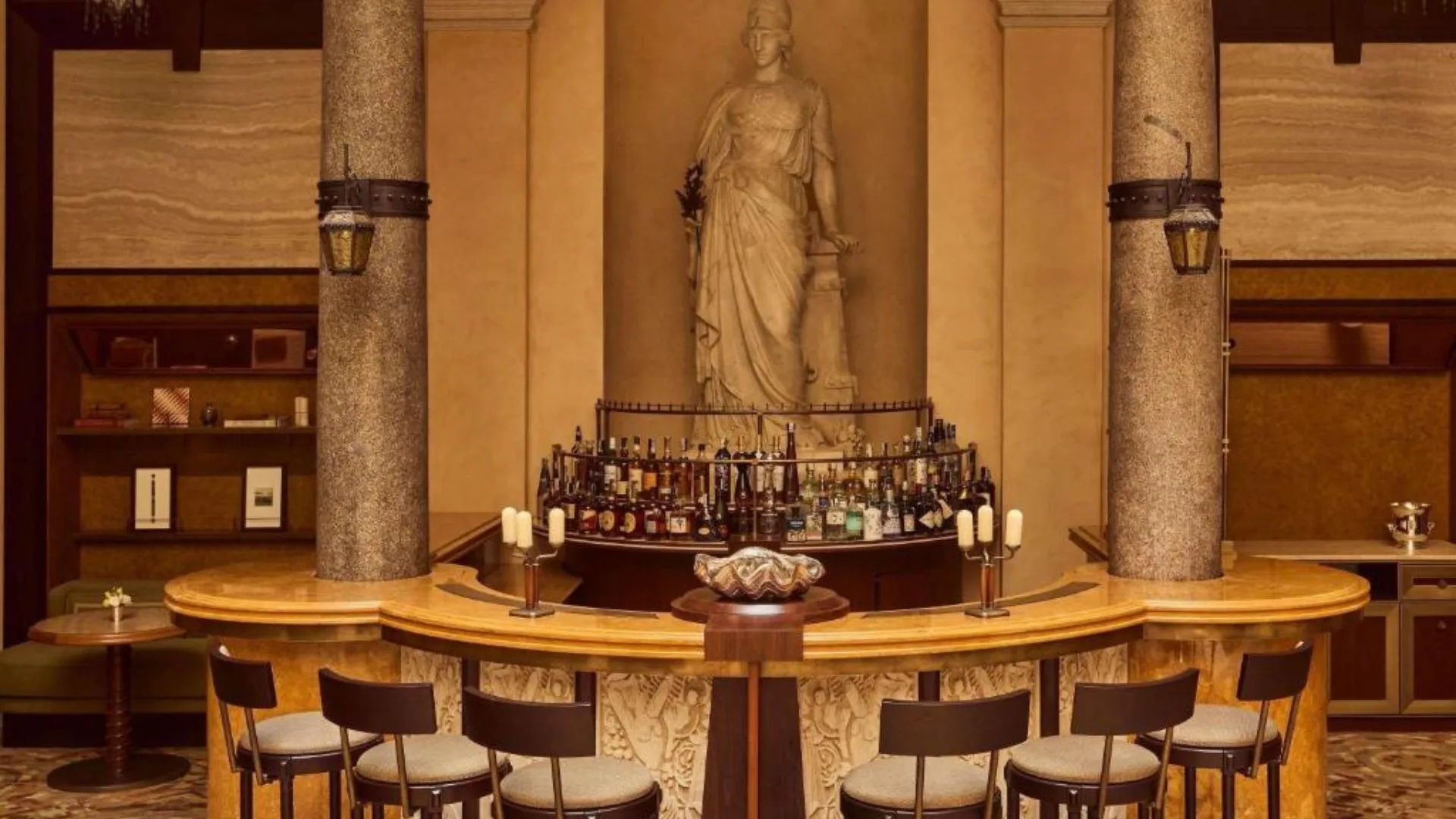 The bar at Orient Express La Minerva boasts an original sculpture of the Minerva goddess