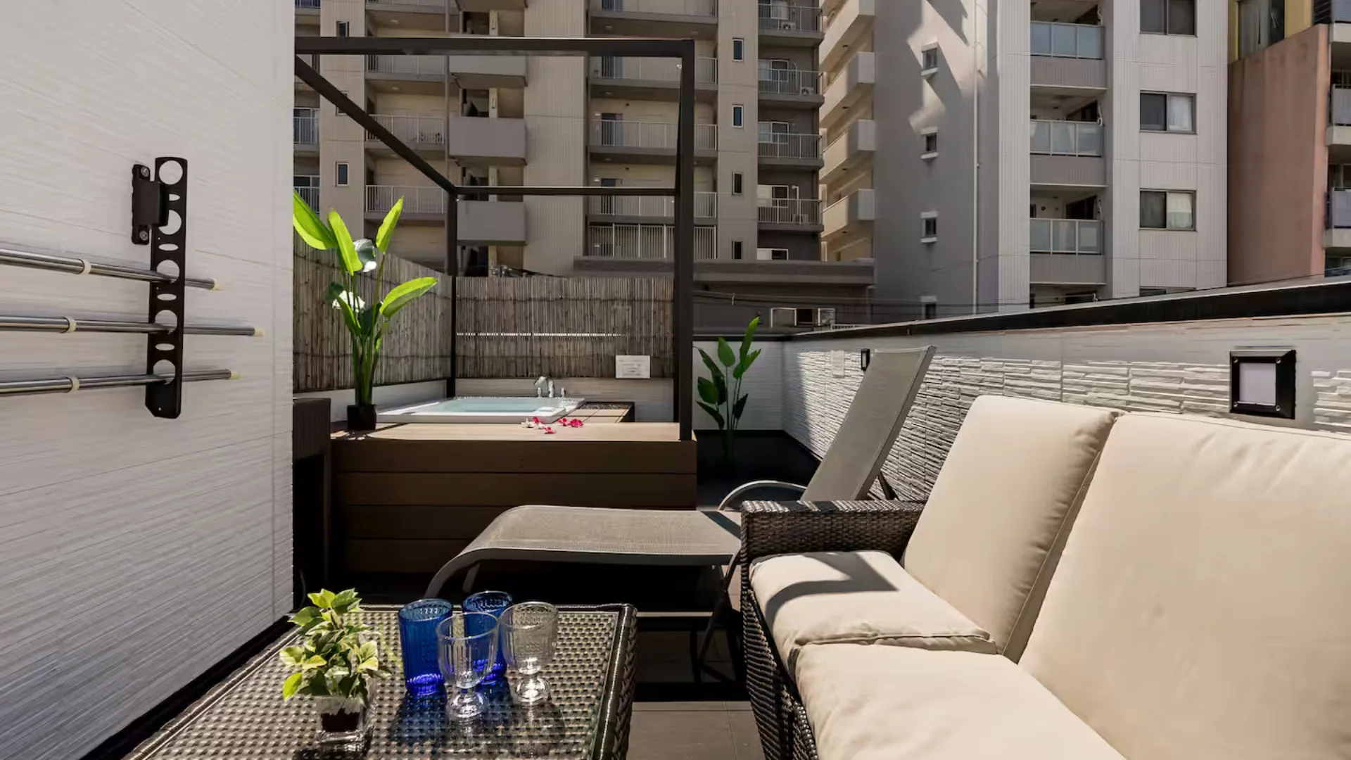 The private rooftop pool and loungers at JR Namba Station apartment