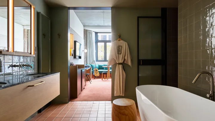 The standalone tub and tiled floors at the bathroom in the Large Suite at Ace Hotel in Sydney.