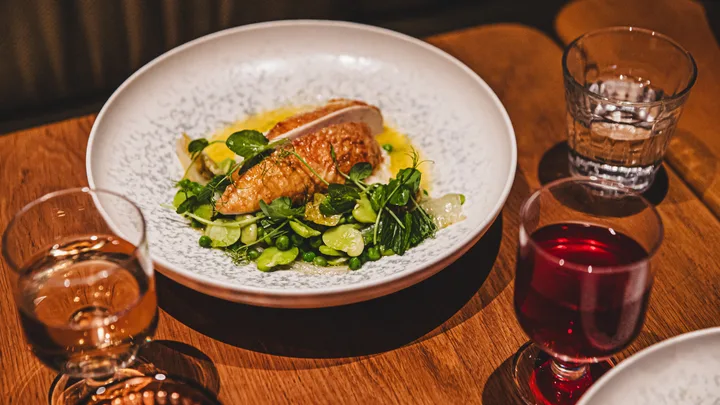 A dining table set with meals and drinks at Kiln restaurant in the Ace Hotel in Sydney.