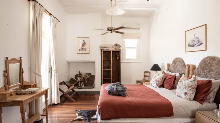The interior of a master suite at Arkaba Homestead with rustic furnishing.