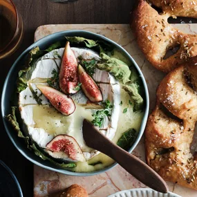 Fig leaf-baked brie with pickled figs and fennel seed fougasse