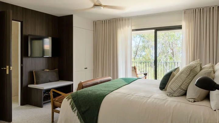 The crisp white interior of the main bedroom at the Lodge at Bells at Killcare.