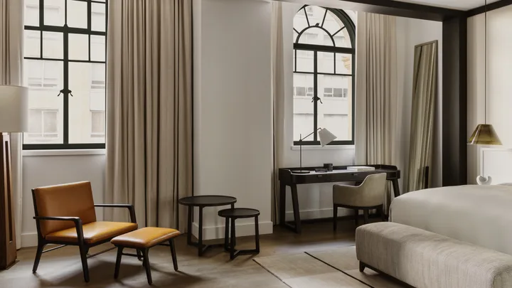The classic design of the Premier King Suite lounge area at Capella Sydney.