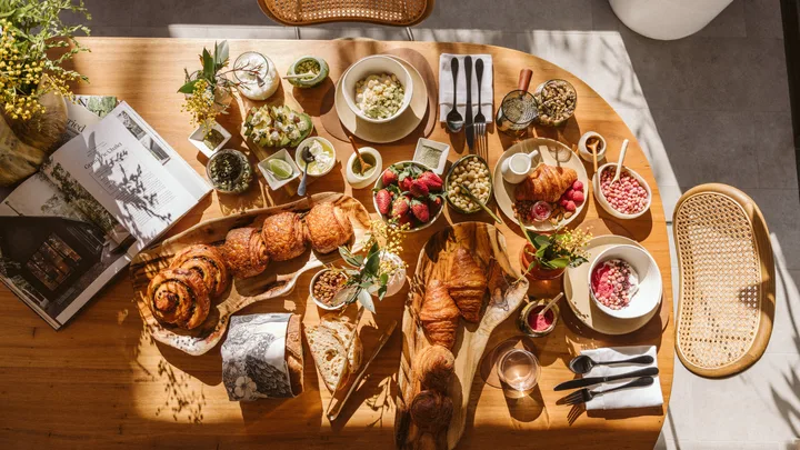 A breakfast table with bread, pastries and fruit at the Chalets at Blackheath in the Blue Mountains.