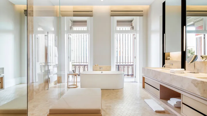 The elegant white balcony bathroom with standalone bath and dual vanities