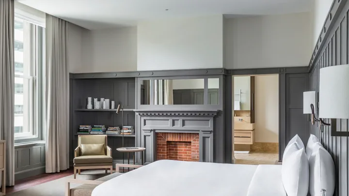 The Cabinet Suite at Como The Treasury with traditional wood panelling, slate grey colour palette and fireplace