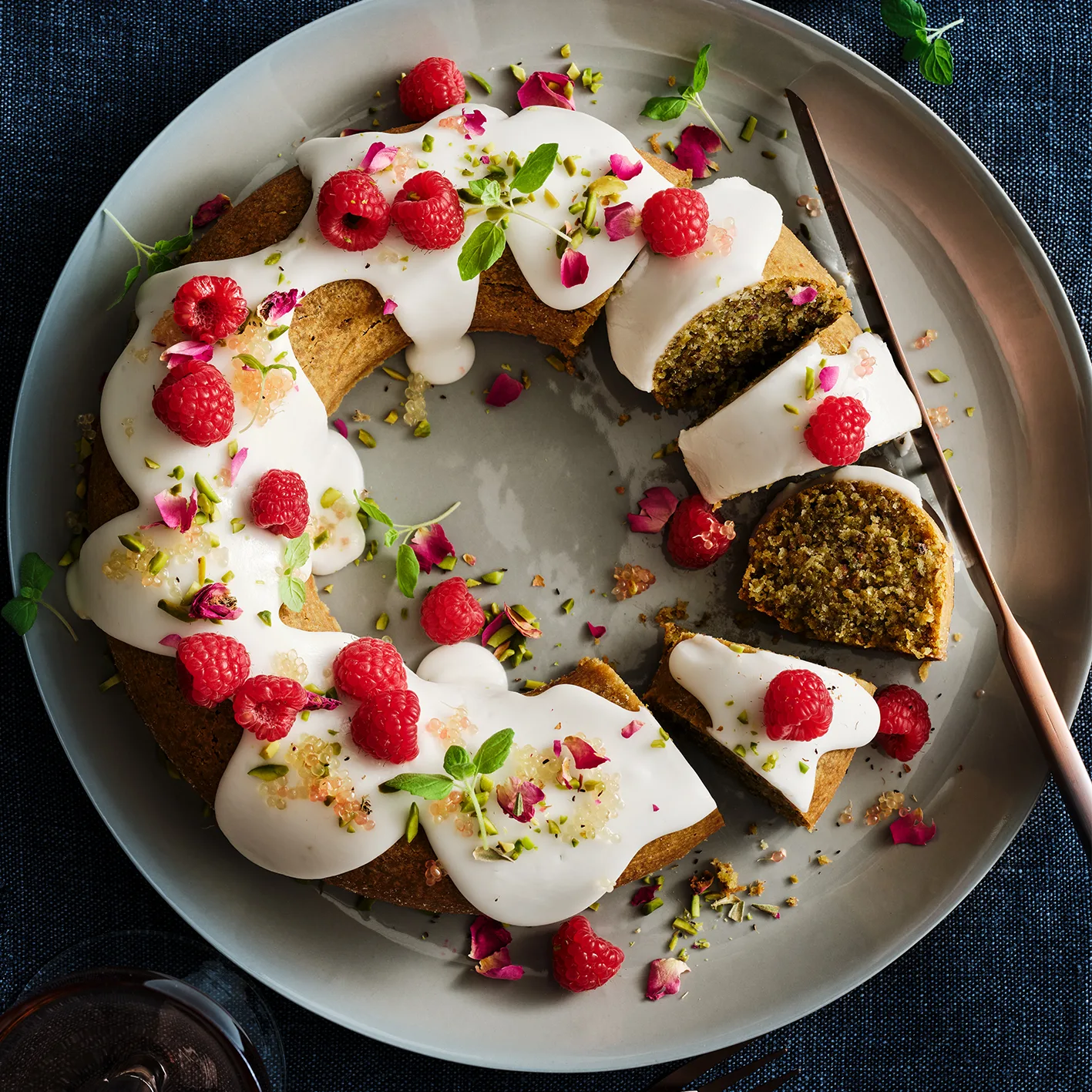 Flourless fig leaf and pistachio cake with rose and raspberries