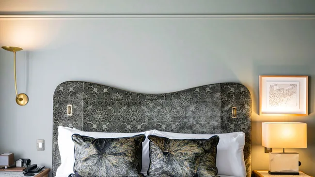 The cool grey tones of the bedroom suite at The Grand National Hotel, Paddington