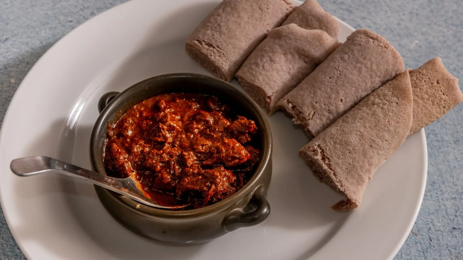 Siga Wot (spicy beef stew) with injera bread at Ethiopian restaurant Gursha in Western Sydney