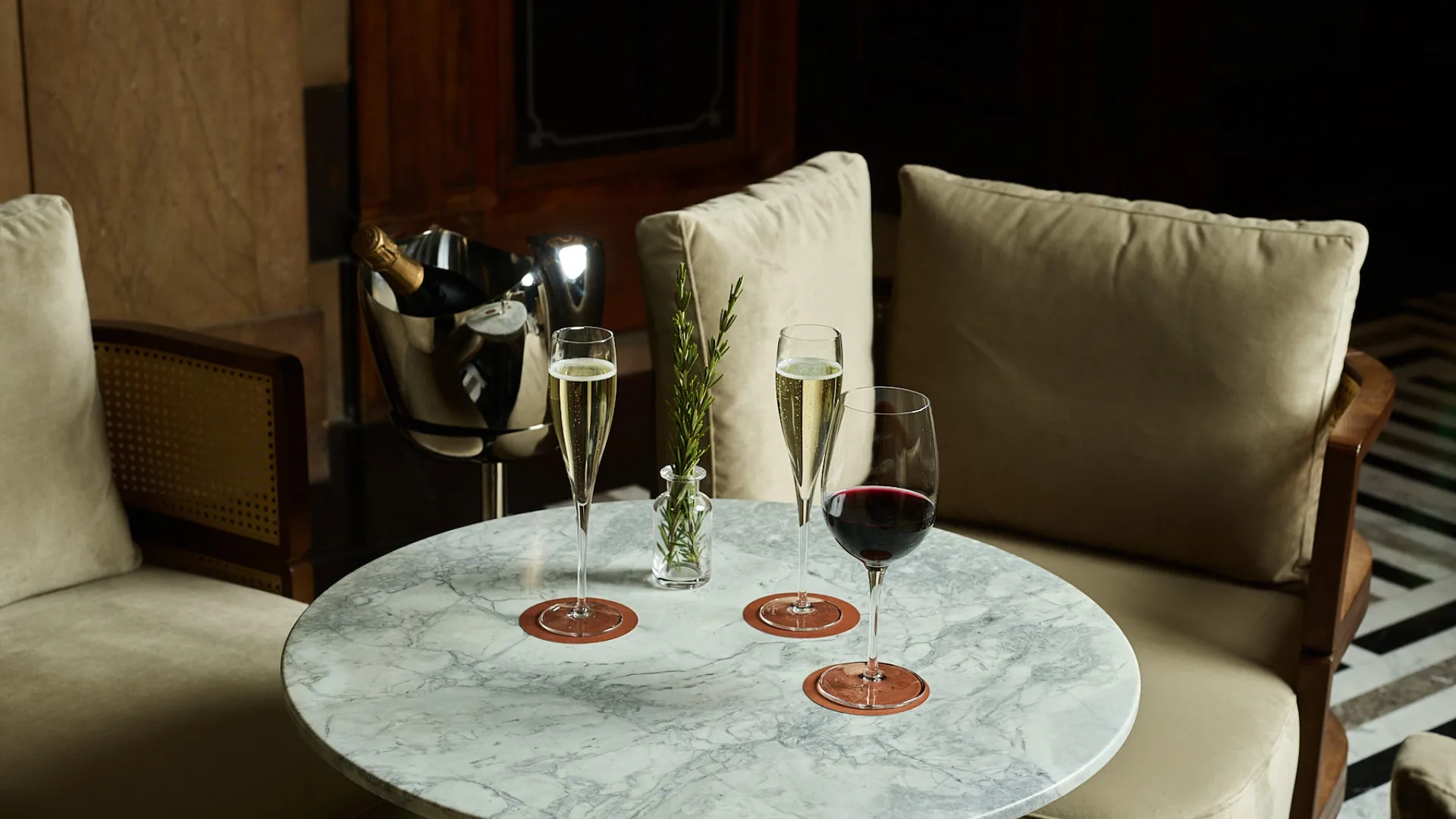 Glasses of wine and champagne on a marble table at Luci Restaurant, Hilton Little Queen Street, Melbourne