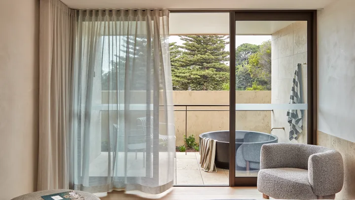 The airy bedroom leads out onto a balcony with standalone bathtub, Hotel Sorrento, Mornington Peninsula.