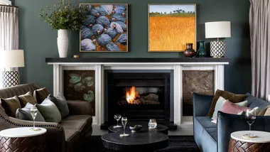 The plush interior of the Argyle Bar with an open fire at Lake House