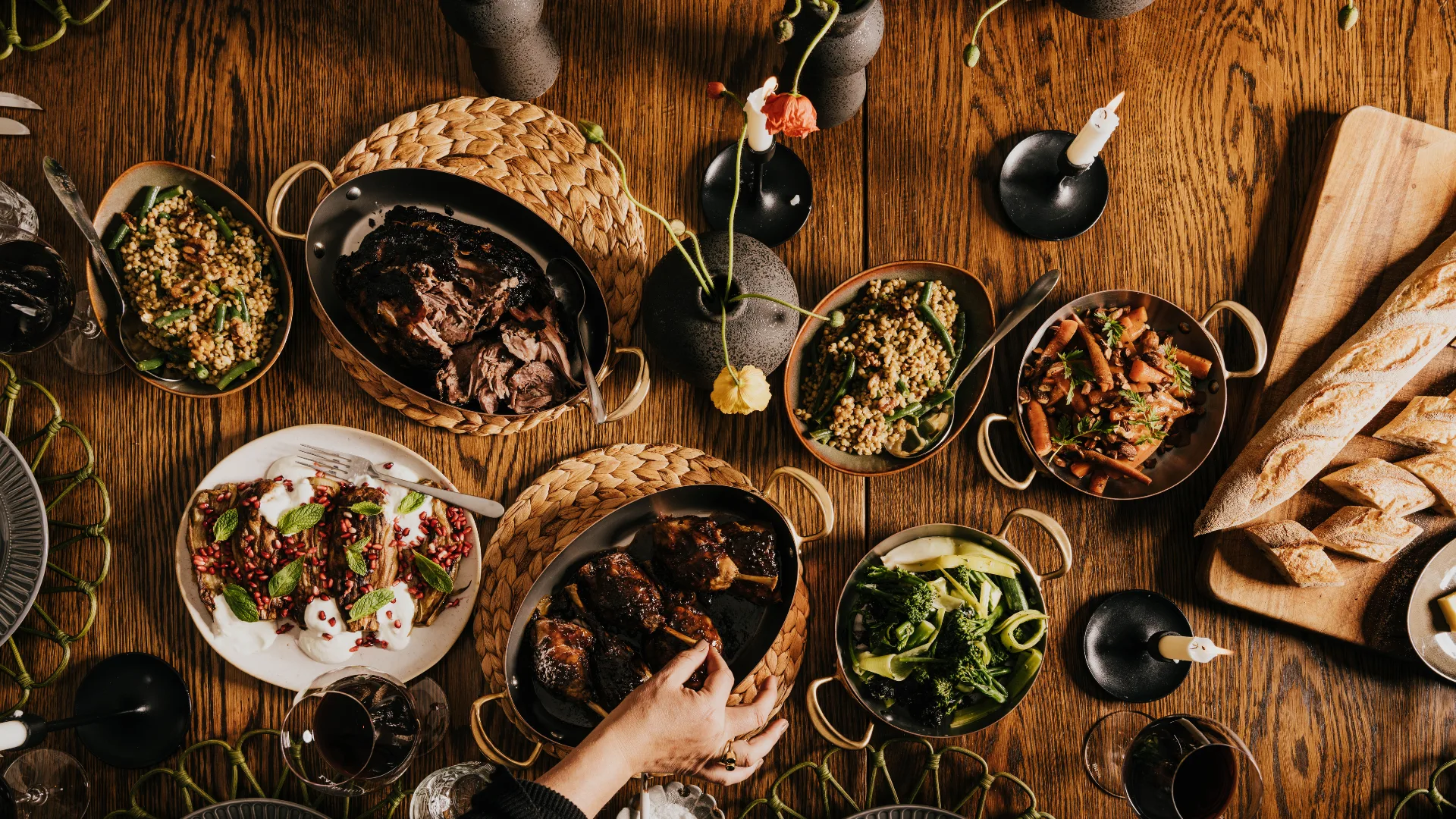 A rustic dining table with several dishes of hearty food at Dairy Flat Farm, Lake House