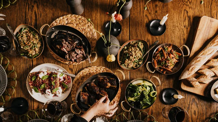 A rustic dining table with several dishes of hearty food at Dairy Flat Farm, Lake House