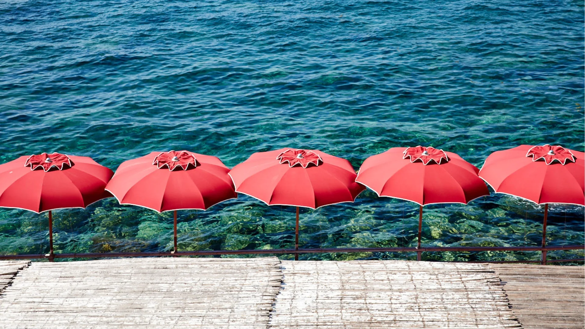 Red beach umbrellas at a lido in Capri Italy