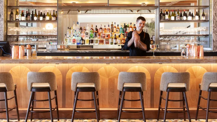 A bartender mixes cocktails at 55 North Bar at Manly Pacific
