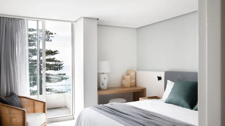 The crisp white interior of the Coastal Villa bedroom at Manly Pacific