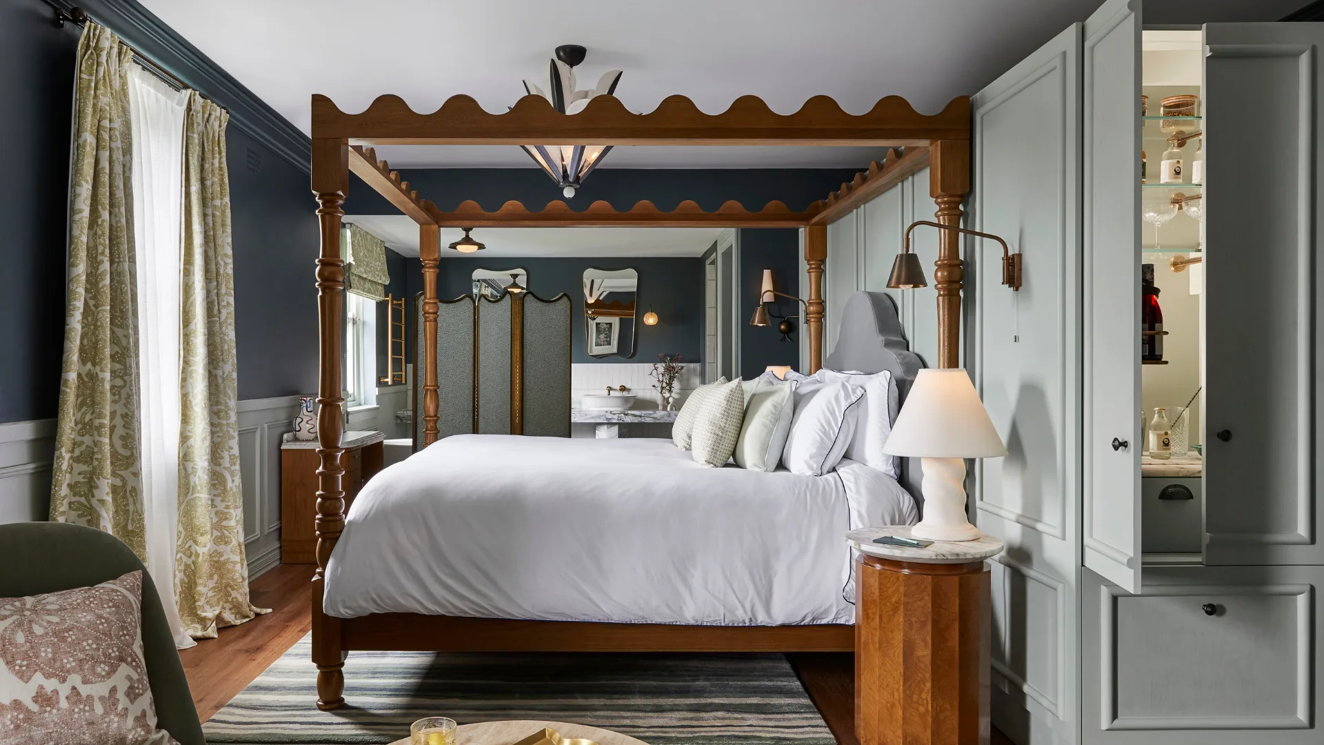 The luxurious interior of the Premier Suite bedroom with four-poster bed at Osborn House.