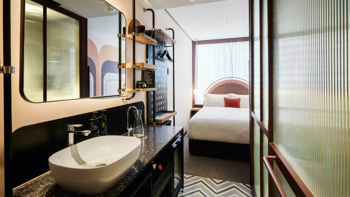 The bathroom at the Sun Gogo Suite with adjacent bedroom at Ovolo South Yarra.