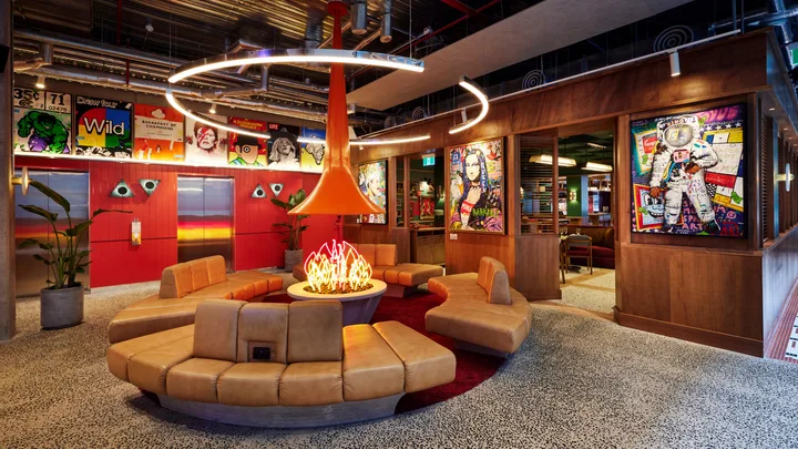 Seventies-style decor with faux fire pit and round bench seating at Ovolo South Yarra.