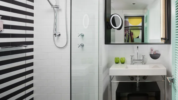 The chic black-and-white striped tiles of a bathroom at QT Gold Coast