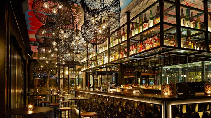 Yamagen Restaurant has a floor-to-ceiling bar and fishnet-inspired hanging lamps at QT Gold Coast