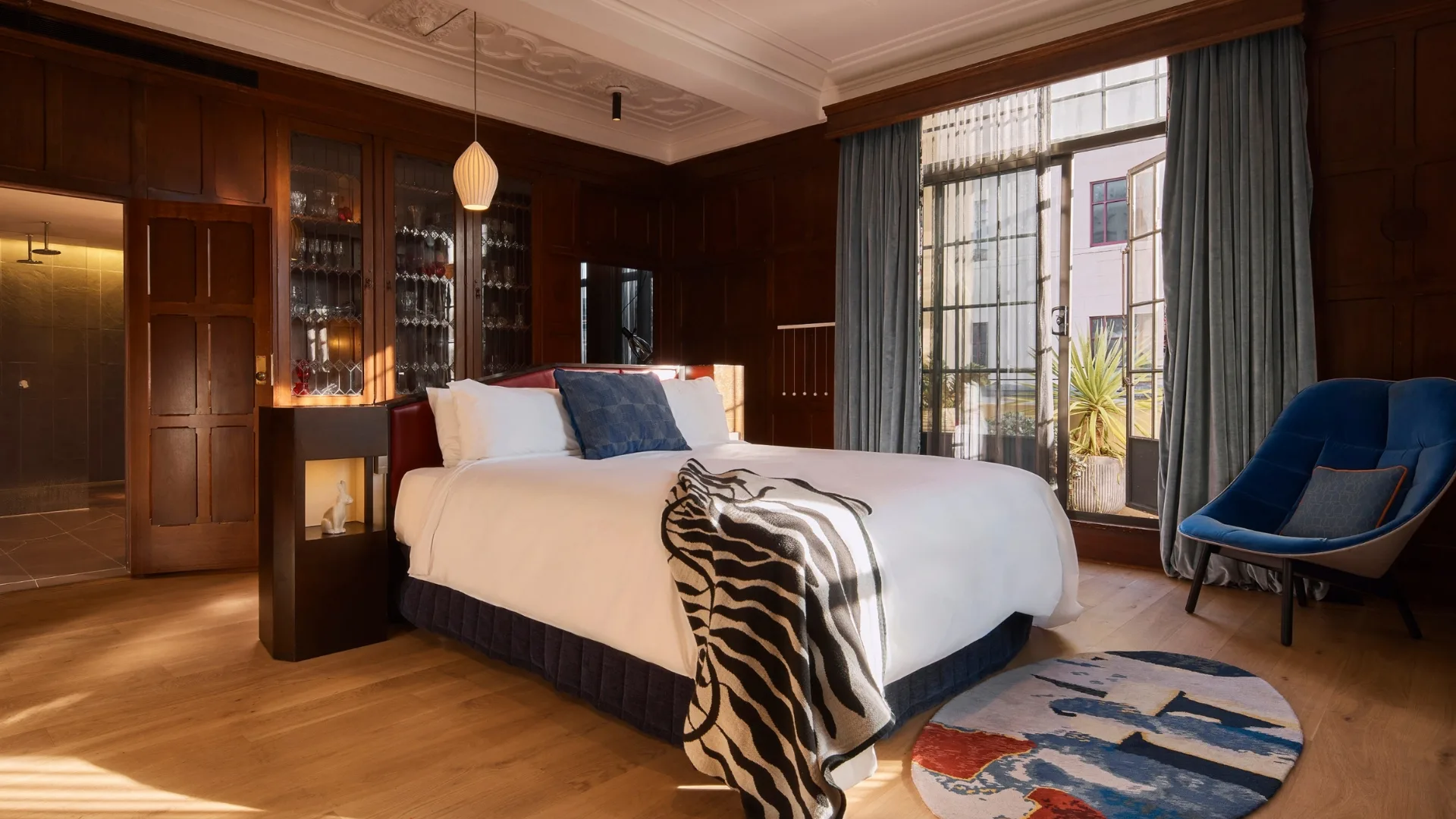 The spacious Sydney State suite bedroom with crisp white bed linen and a private balcony.