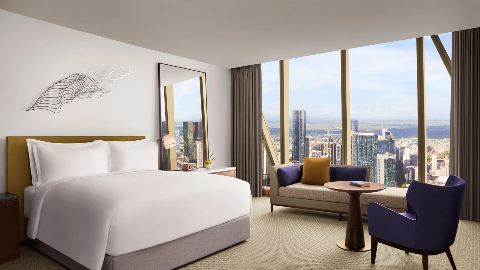 The spacious neutrals-toned Executive Suite Bedroom with sweeping city views at The Ritz-Carlton Melbourne