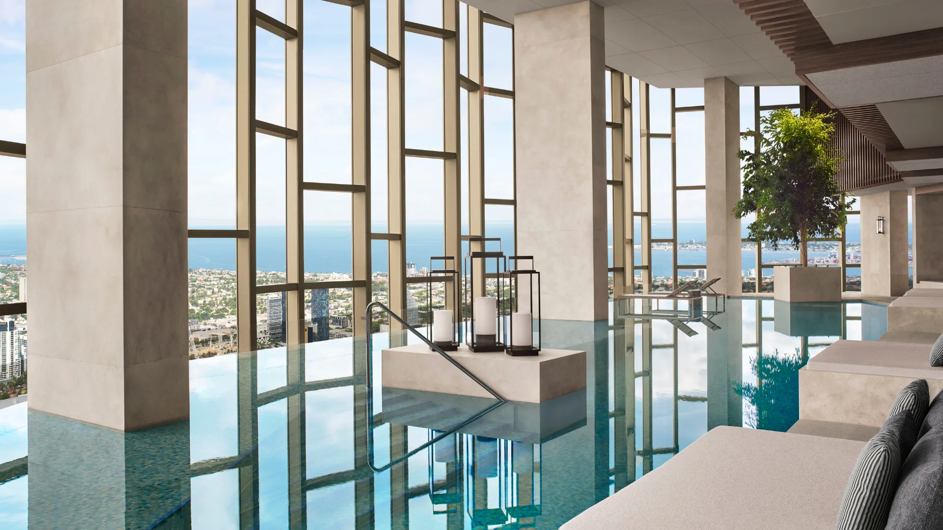 The infinity pool with elegant floor to ceiling windows overlooking the city at The Ritz-Carlton Melbourne
