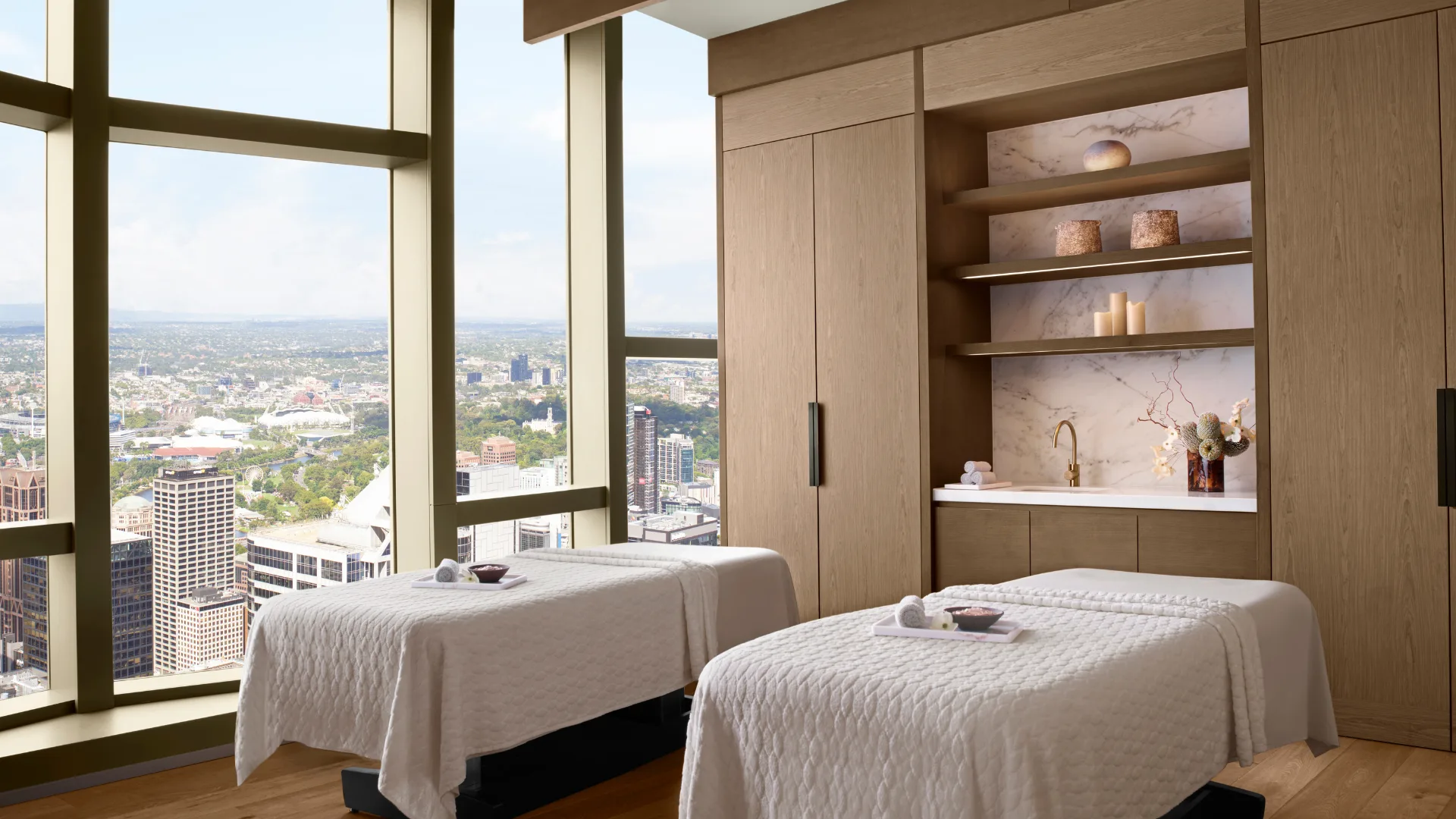 Two massage beds side-by-side with city views at the Spa, at The Ritz-Carlton Melbourne