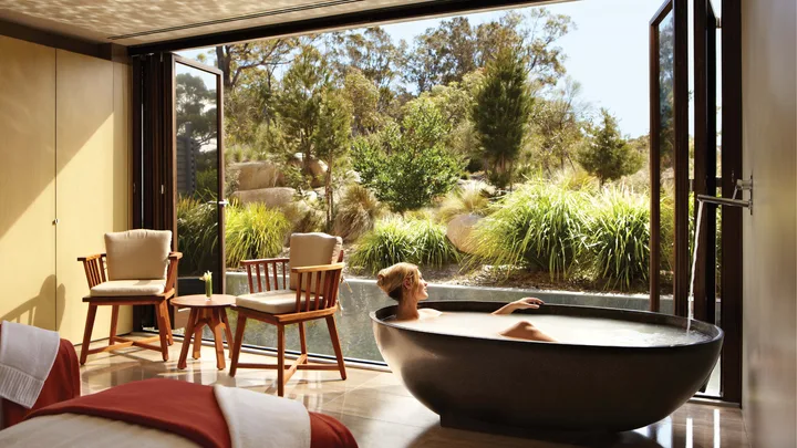 A freestanding tub opens out onto a deck at the Spa at Saffire Freycinet